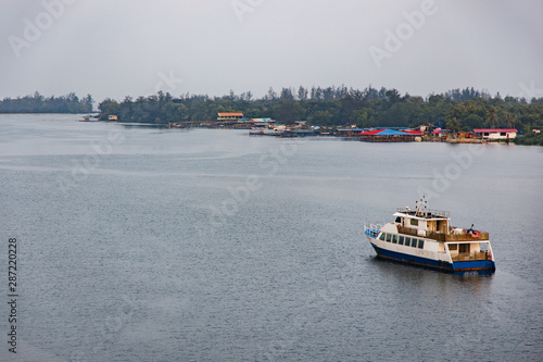 View of Mengkabong River with Boats and Houses in the Morning