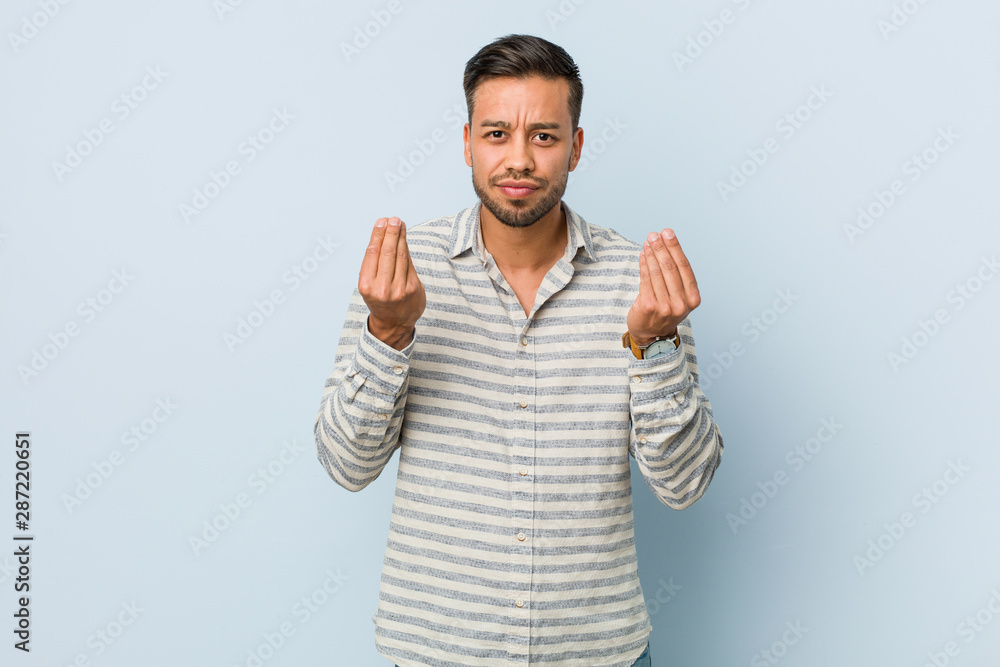Young handsome filipino man showing that she has no money. Young handsome filipino man showing that she has no money.