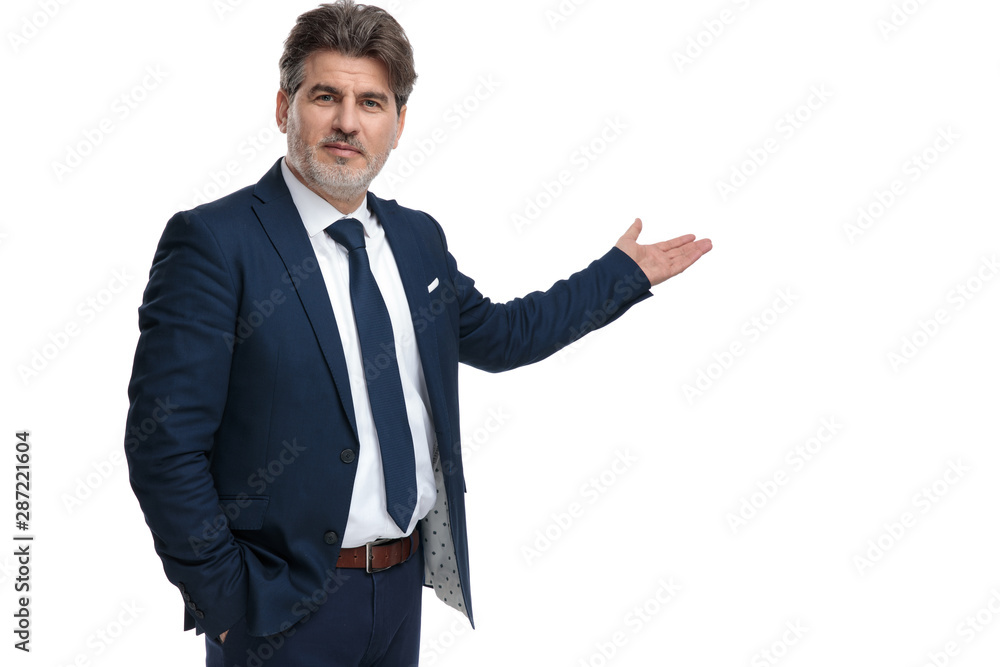 Confident businessman holding his hand in his pocket and recommending Confident businessman holding his hand in his pocket and recommending