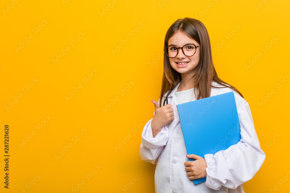 Little caucasian girl wearing a doctor costume happy, smiling and cheerful. Little caucasian girl wearing a doctor costume happy, smiling and cheerful.