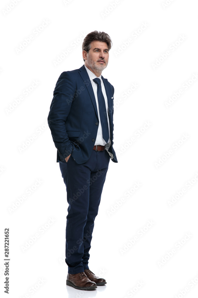 Optimistic businessman holding both hands in his pockets Optimistic businessman holding both hands in his pockets