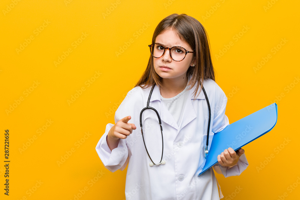 Little caucasian girl wearing a doctor costume Little caucasian girl wearing a doctor costume