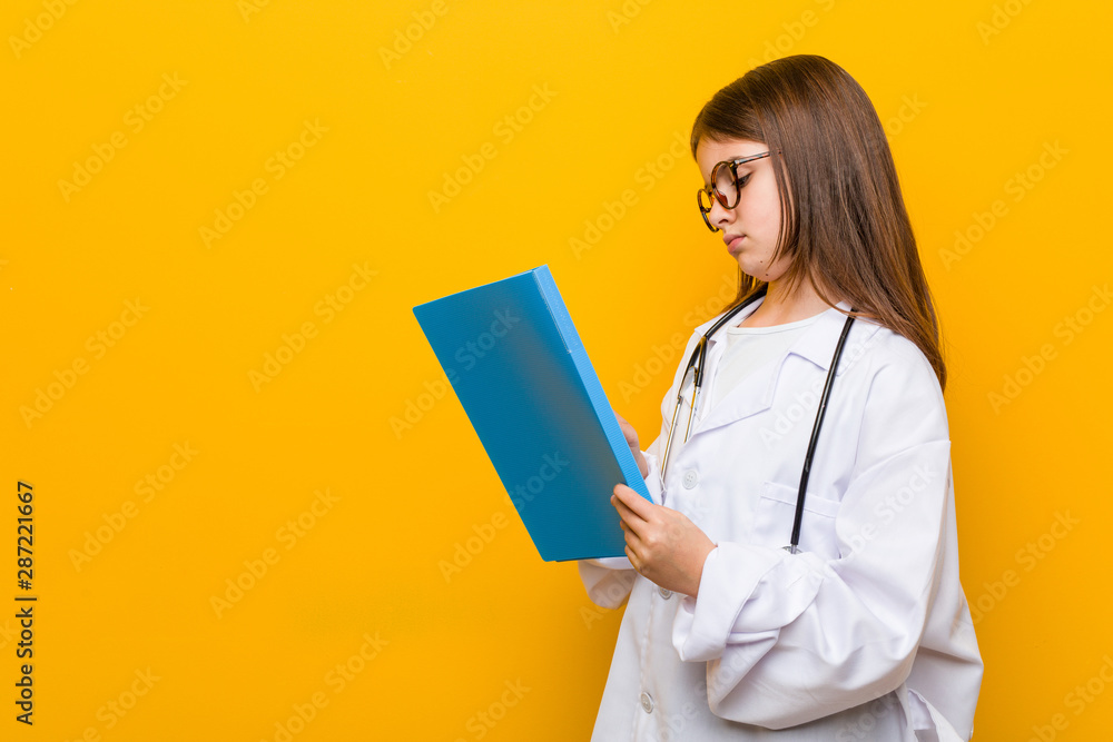Little caucasian girl wearing a doctor costume Little caucasian girl wearing a doctor costume