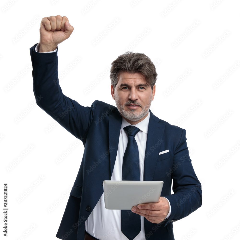 Old businessman holding his tablet and celebrating Old businessman holding his tablet and celebrating