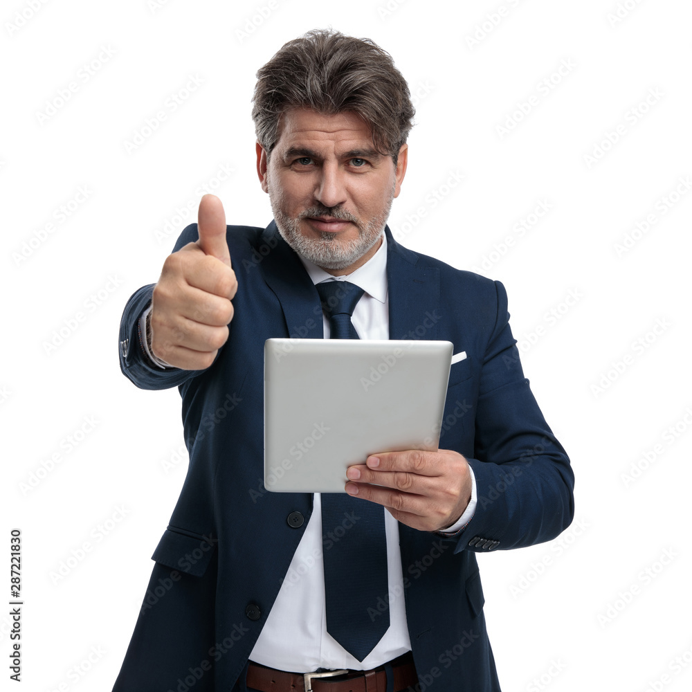 Happy businessman holding a tablet and gesturing ok Happy businessman holding a tablet and gesturing ok
