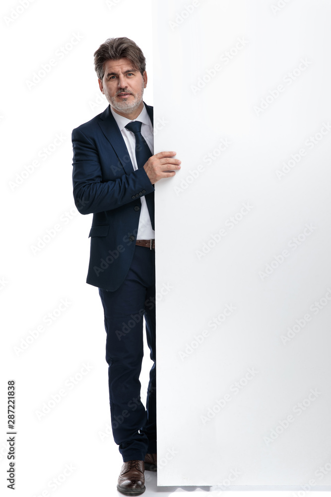 Modern businessman holding and empty billboard Modern businessman holding and empty billboard