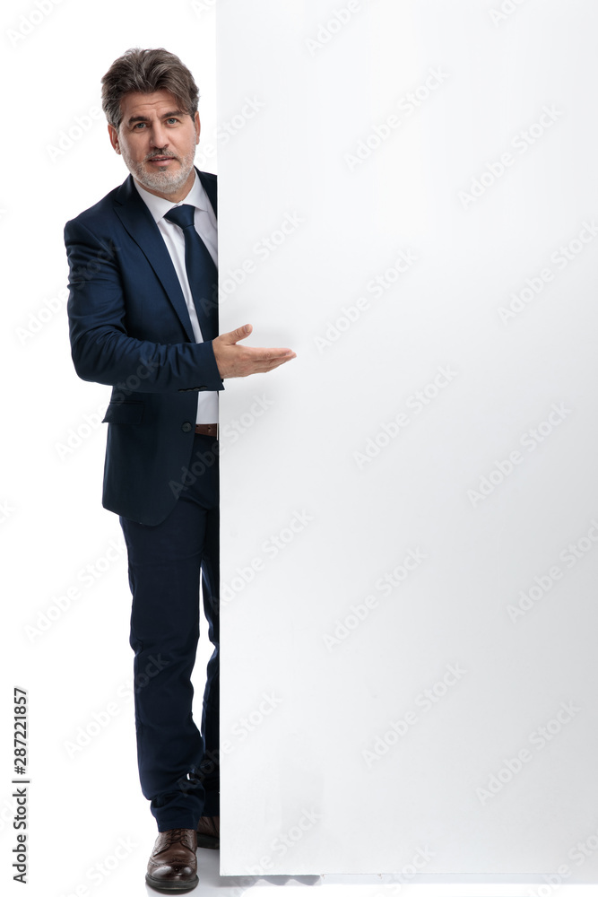 Old businessman presenting an empty billboard Old businessman presenting an empty billboard