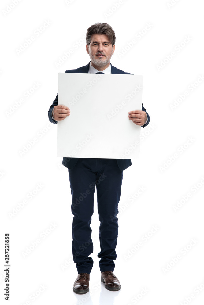 Elegant businessman holding an empty advertisement Elegant businessman holding an empty advertisement