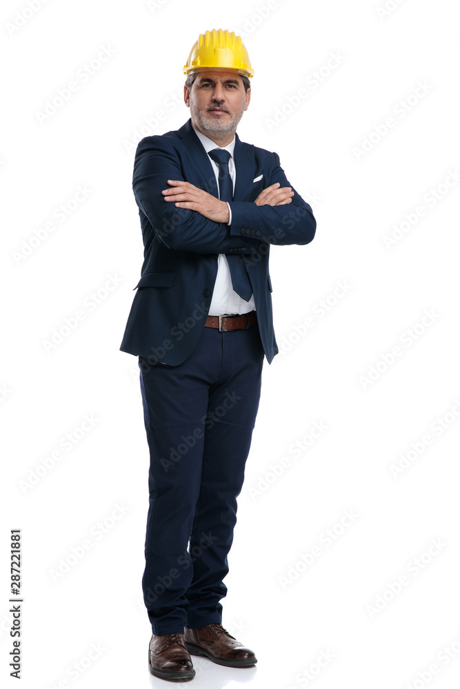 Smart businessman wearing a safety cap and a blue suit Smart businessman wearing a safety cap and a blue suit