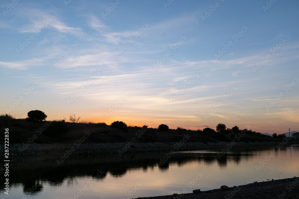 sunset at the mouth of the Guadalmedina river in malaga sunset at the mouth of the Guadalmedina river in malaga