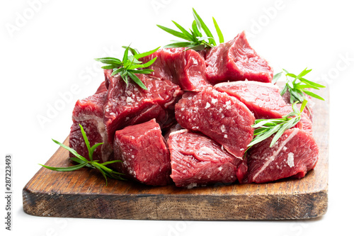 Sliced raw beef with tarragon herb isolated on white