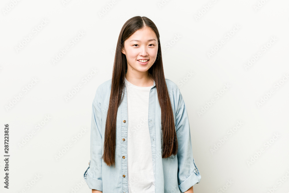 Young asian woman happy, smiling and cheerful. Young asian woman happy, smiling and cheerful.