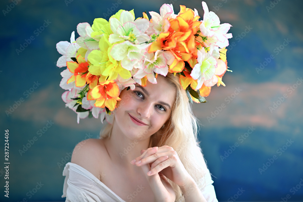 A close-up portrait of a cute blonde girl, a young woman with a wreath of flowers on her head with beautiful curly hair on a colored background with excellent facial skin. Beauty, brightness. A close-up portrait of a cute blonde girl, a young woman with a wreath of flowers on her head with beautiful curly hair on a colored background with excellent facial skin. Beauty, brightness.