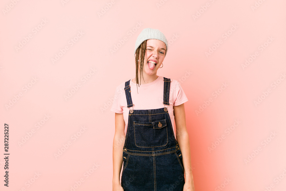 Hispter teenager woman funny and friendly sticking out tongue. Hispter teenager woman funny and friendly sticking out tongue.