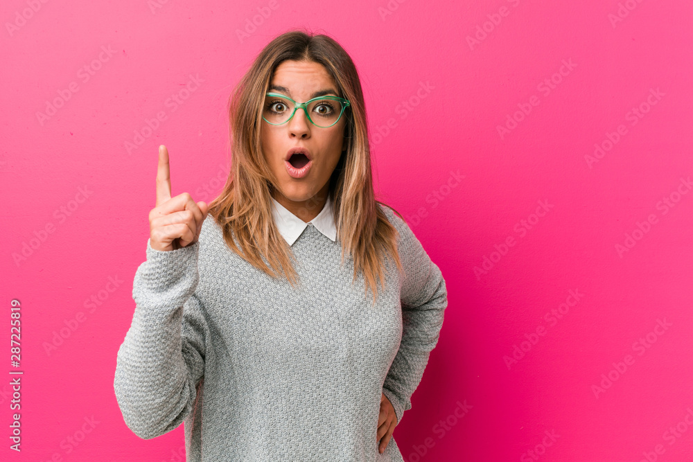 Young authentic charismatic real people woman against a wall having an idea, inspiration concept. Young authentic charismatic real people woman against a wall having an idea, inspiration concept.
