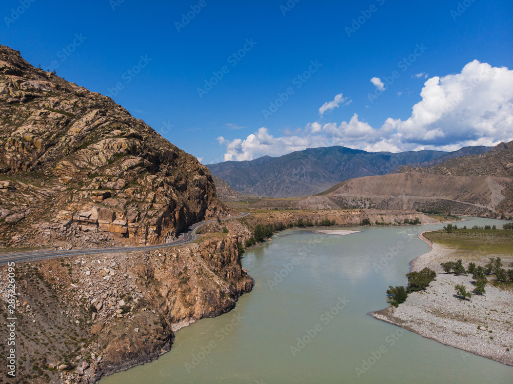 Road in Altai mountains. Chuysky tract in Altai Republic, Siberia, Russia. This road is one of the ten most beautiful roads in the world. Road in Altai mountains. Chuysky tract in Altai Republic, Siberia, Russia. This road is one of the ten most beautiful roads in the world.