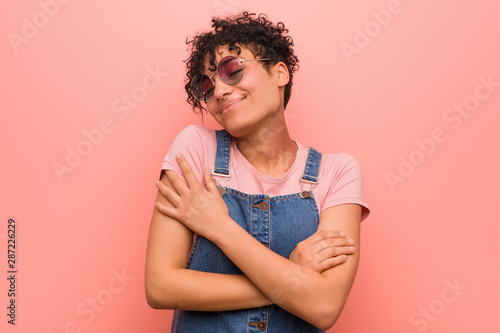 Young mixed african american teenager woman hugs, smiling carefree and happy.