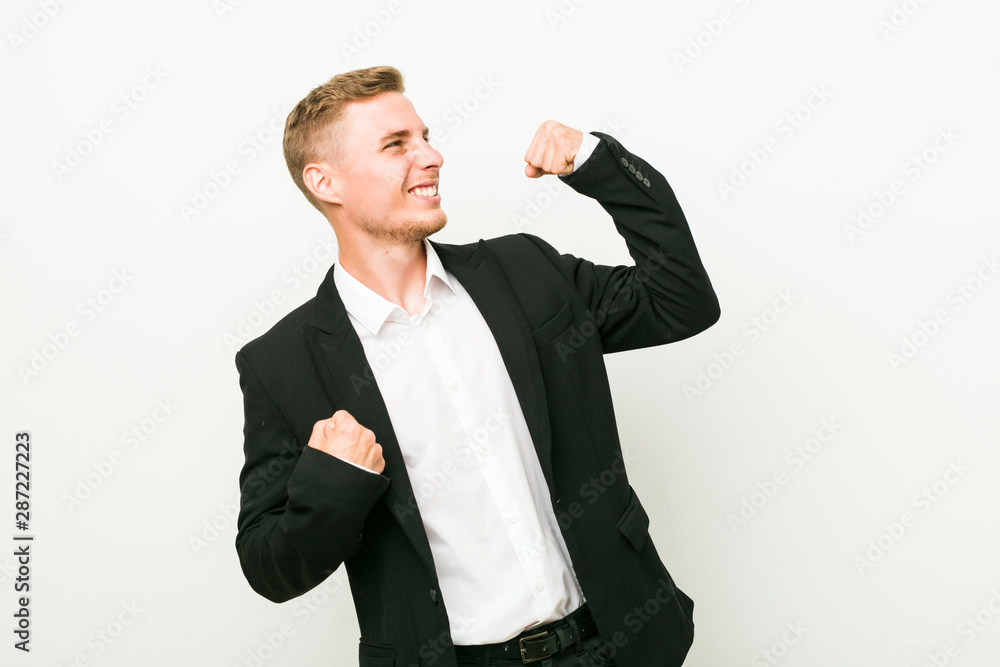 Young caucasian business man raising fist after a victory, winner concept. Young caucasian business man raising fist after a victory, winner concept.
