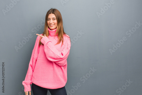 Young russian natural girl smiling and pointing to the side
