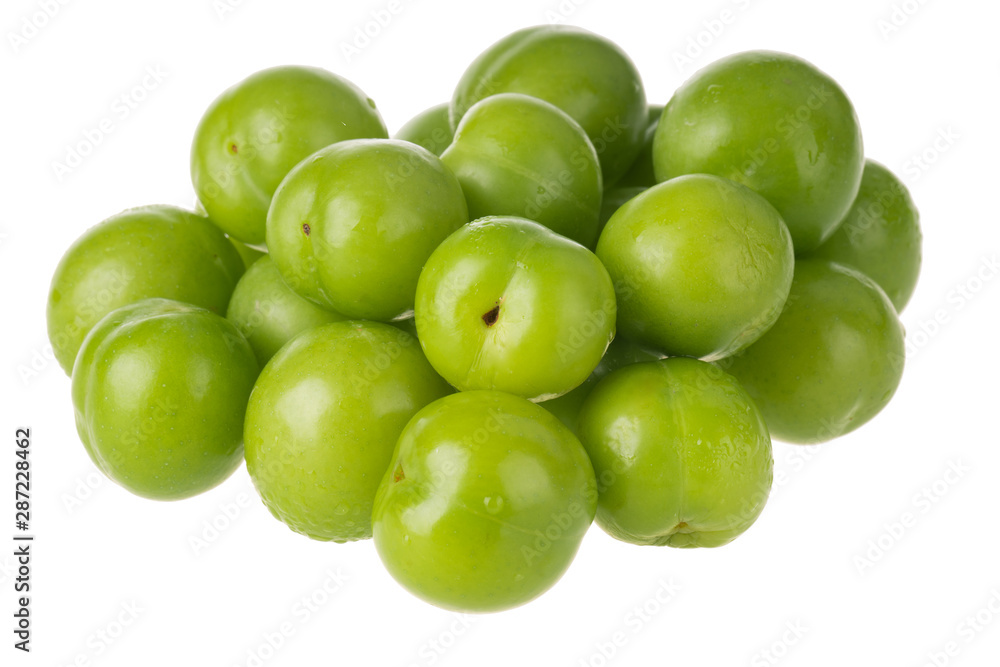 heap of green cherry-plum isolated on white background