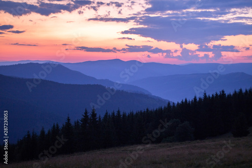 Fototapeta Naklejka Na Ścianę i Meble -  red-blue sunset haze in the mountain gorge, orange-blue sunset in the mountains