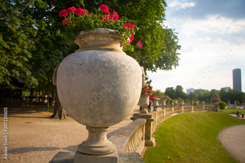 Luxembourg gardens ornamental statue, tropical flowers and trees in flowerpots and tubs