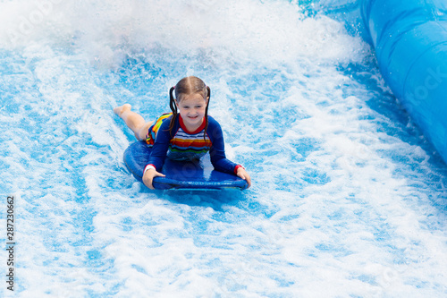Little girl surfing in beach wave simulator © famveldman