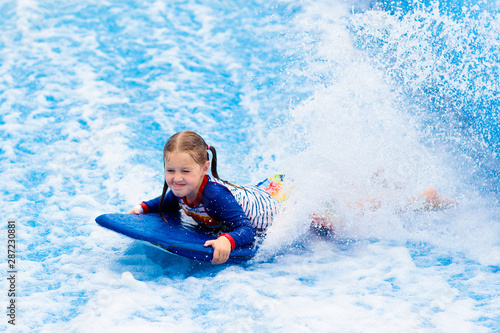 Little girl surfing in beach wave simulator © famveldman