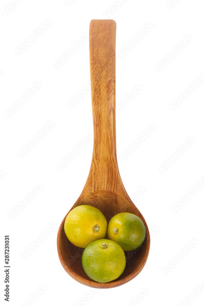 fresh limequat on white background in wooden spoon fresh limequat on white background in wooden spoon