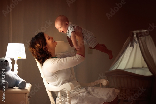 Mother and baby in dark bedroom