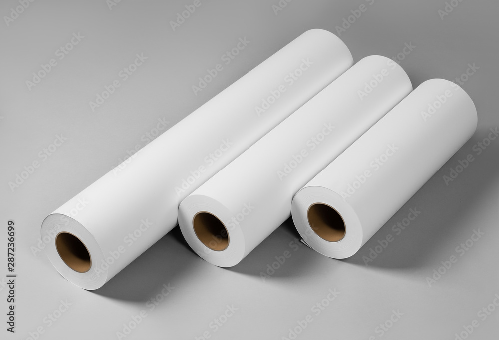 Fototapeta premium Blank white paper rolls isolated on gray background. Mockup paper for magazines, catalogs or newspapers isolated on gray backdrop, Printing house theme or wrapping paper for presents