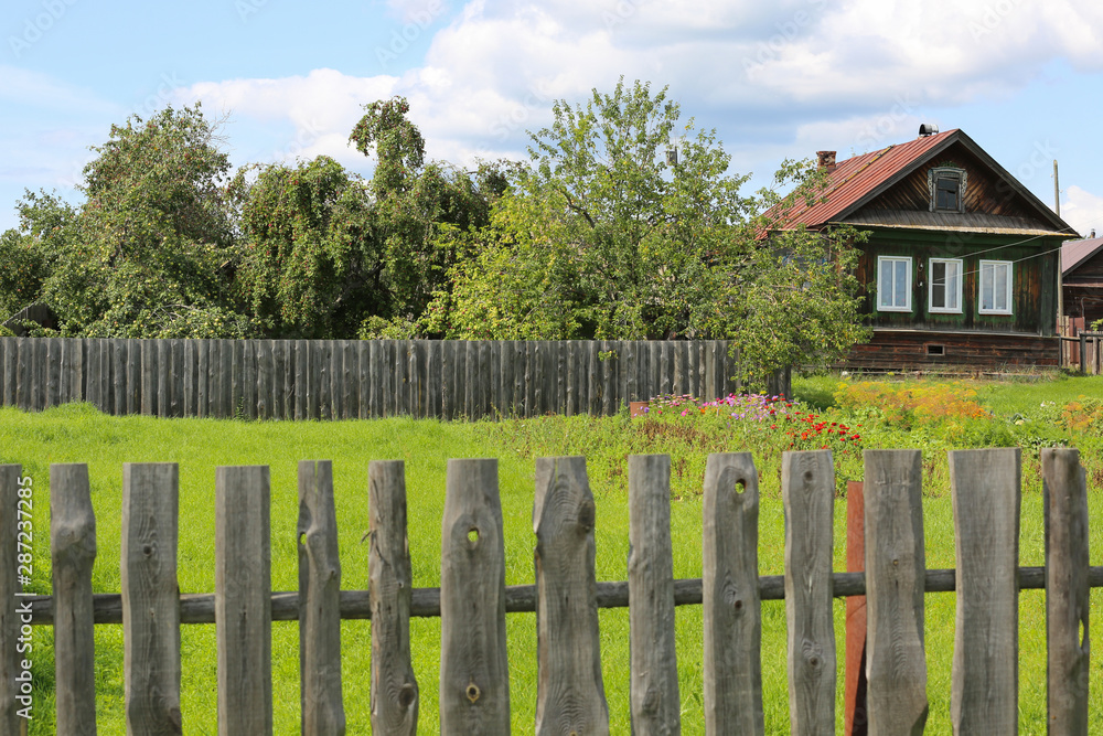 Russian village in summer. Old wooden house with window shutters. Village of Sidelnikovo, Mari- El Republik, Russia.