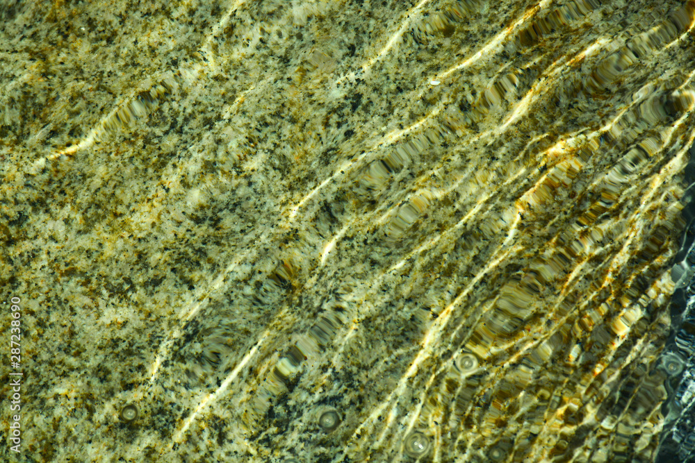 Natural granite under water. Waves create a unique pattern. Natural granite under water. Waves create a unique pattern.