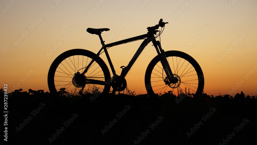 silhouette of bicycle on sunset silhouette of bicycle on sunset