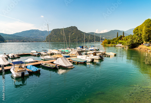 Pier with boats on Lake Lugano in Morcote, Switzerland photo