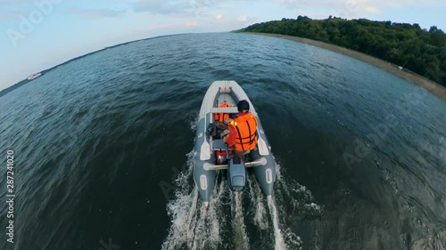 A boatman riding his boat on river. photo