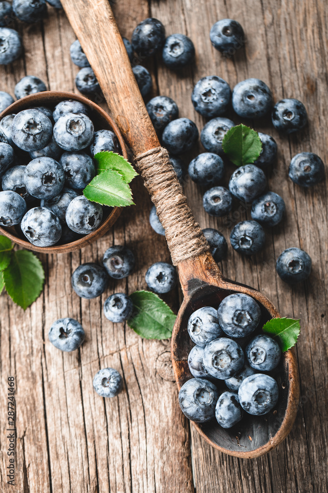 Blueberries in wooden spoon on old wood table. Healthy eating and nutrition concept. Blueberries in wooden spoon on old wood table. Healthy eating and nutrition concept.