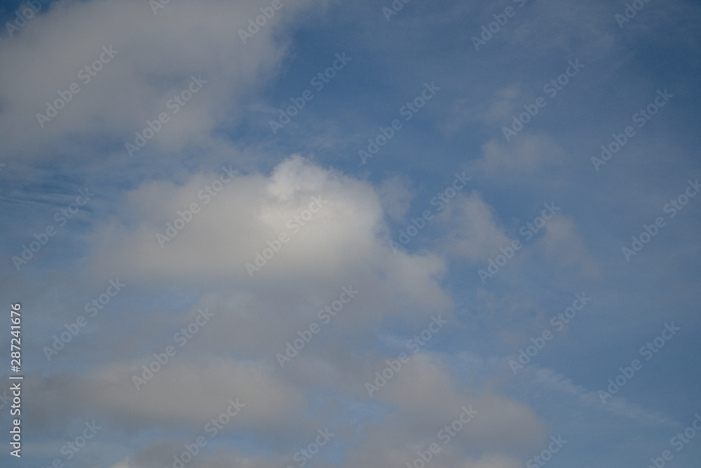 blue sky with airy white clouds. Copy space