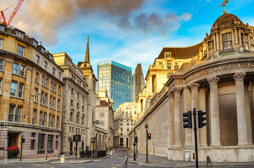 View of Lothbury Street in London Banking District, overlooking a skyscraper and St. Margaret's Church on the left. photo