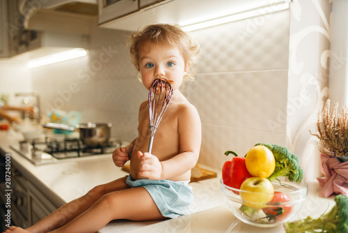 Kid tastes melted chocolate, pastry preparation
