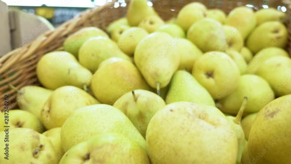 Fresh ripe pears background, pears on a counter in a supermarket. Fresh ripe pears background, pears on a counter in a supermarket.