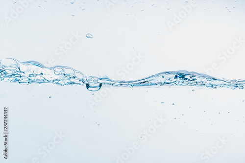 Water splash close up of splash of water forming shape isolated on white background.