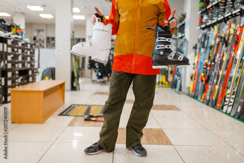 Male person with ski or snowboarding boots