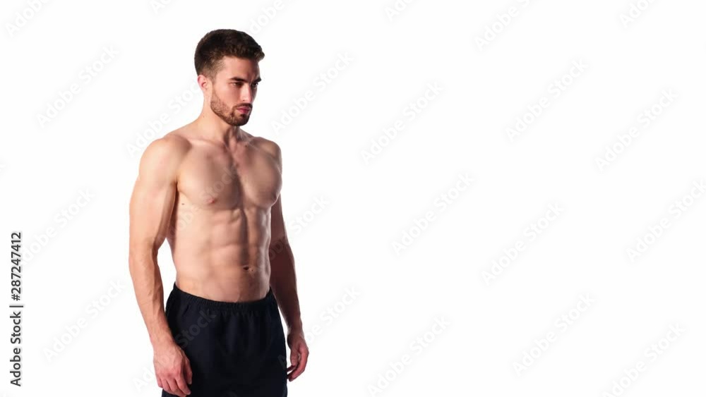 A young sports man with a beard, looking in frame and smiling. The naked torso and muscular muscles of men. Handsome guy looking at camera on a white background A young sports man with a beard, looking in frame and smiling. The naked torso and muscular muscles of men. Handsome guy looking at camera on a white background