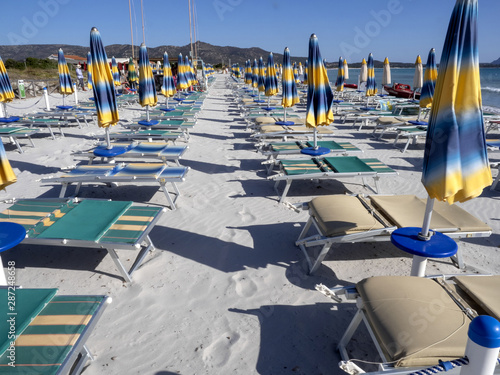 Fototapeta Naklejka Na Ścianę i Meble -  Morning empty beach with parasols, Sardinia, Italy