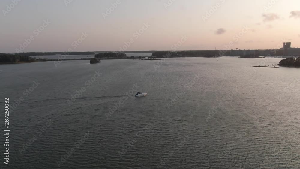 White boat sails at sea and splashing waves. Drone shot. Motorboat. Flying over ocean water. White boat sails at sea and splashing waves. Drone shot. Motorboat. Flying over ocean water.