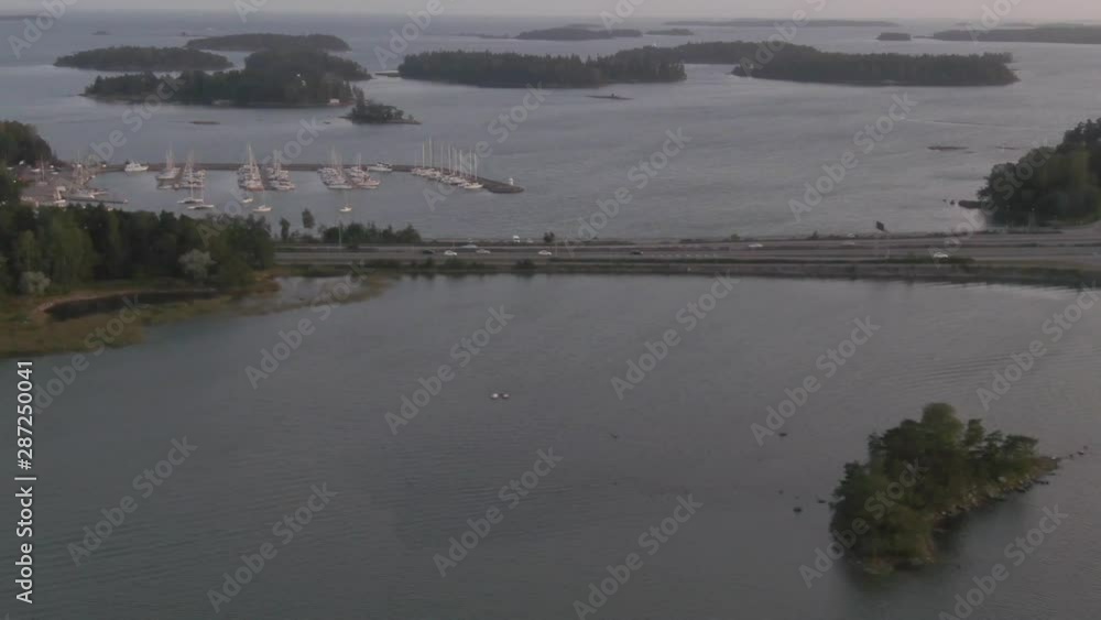 Cars. Traffic on a bridge near boat harbor. Flying over water. Arial drone shot. Islands. Cars. Traffic on a bridge near boat harbor. Flying over water. Arial drone shot. Islands.