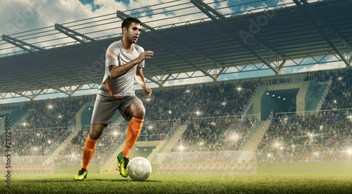 Professional soccer player in action with the ball. Crowded soccer stadium with fans cheering