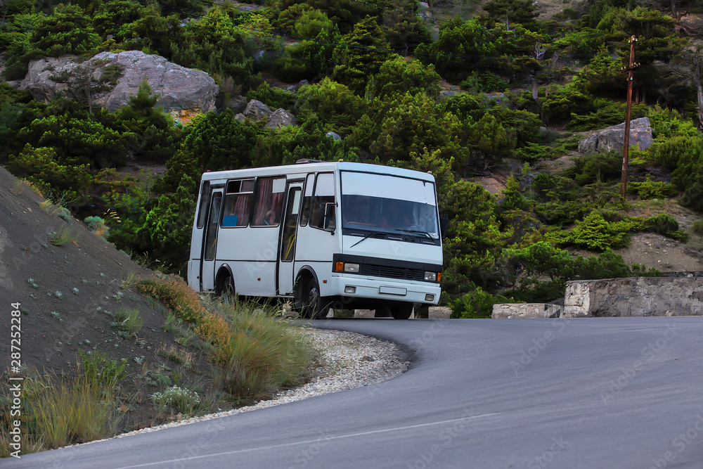 Bus move along a winding mountain road