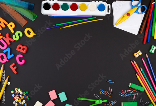 school supplies: multicolored wooden pencils, paper stickers, paper clips